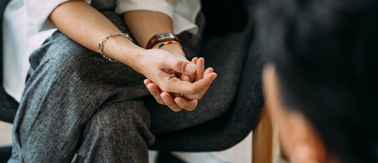 Close-up of woman's hands during counseling meeting with a professional therapist.