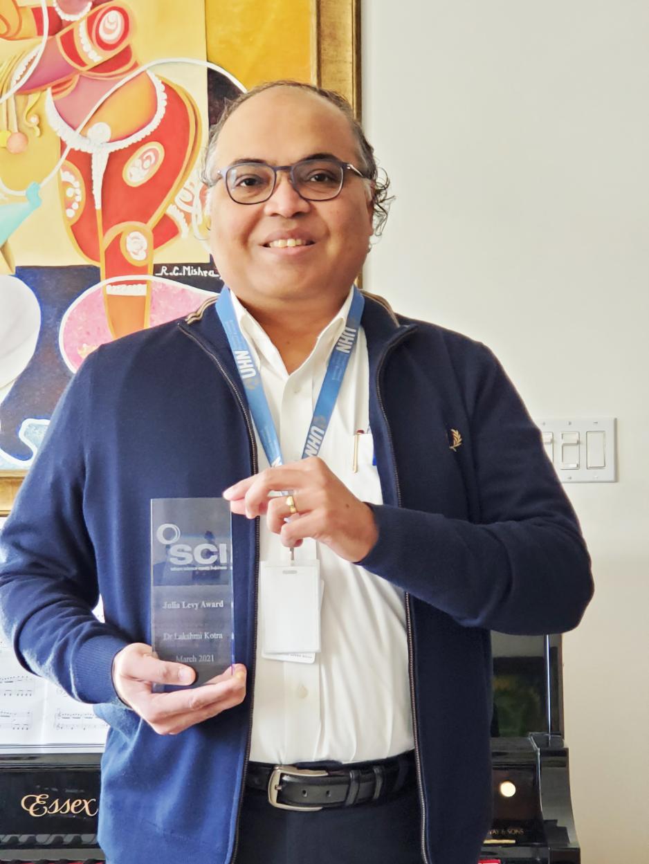 Portrait of Lakshmi Kotra holding SCI Award