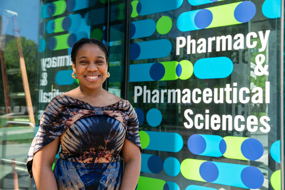 PharmD 2T4 Graduate Theodora Udounwa outside the Pharmacy & Pharmaceutical Sciences Sign at Leslie Dan Faculty of Pharmacy