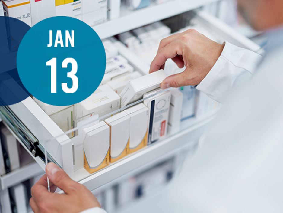 Pharmacist grabbing medication from a drawer in a pharmacy