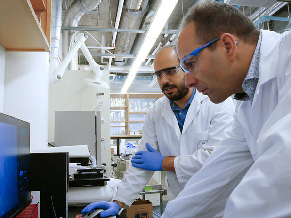 Professor Stephane Angers &amp; Post-doc Rony Chidiac working in lab