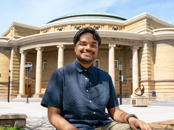 Al-Amin Ahamed photographed outfront of convocation hall