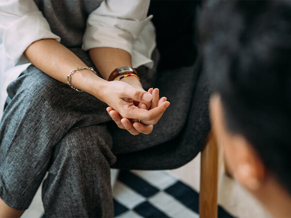 Close-up of woman's hands during counseling meeting with a professional therapist.