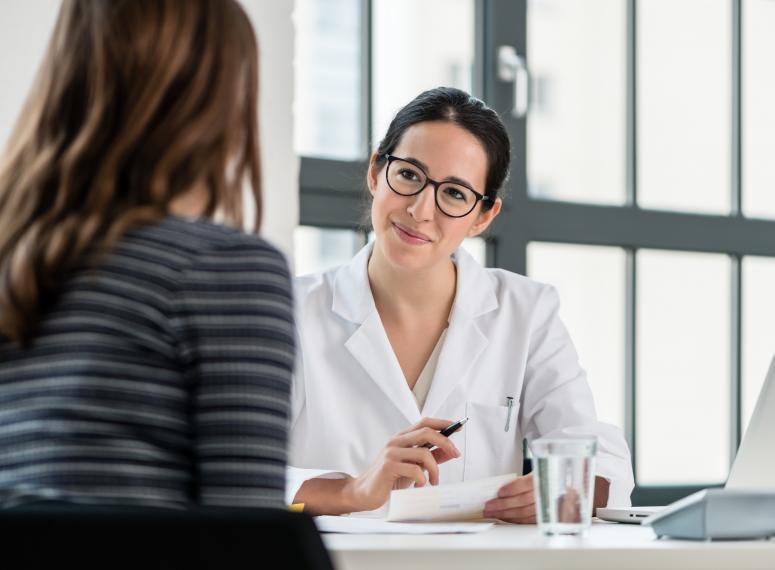 Female pharmacist talking with patient Female pharmacist talking with patient
