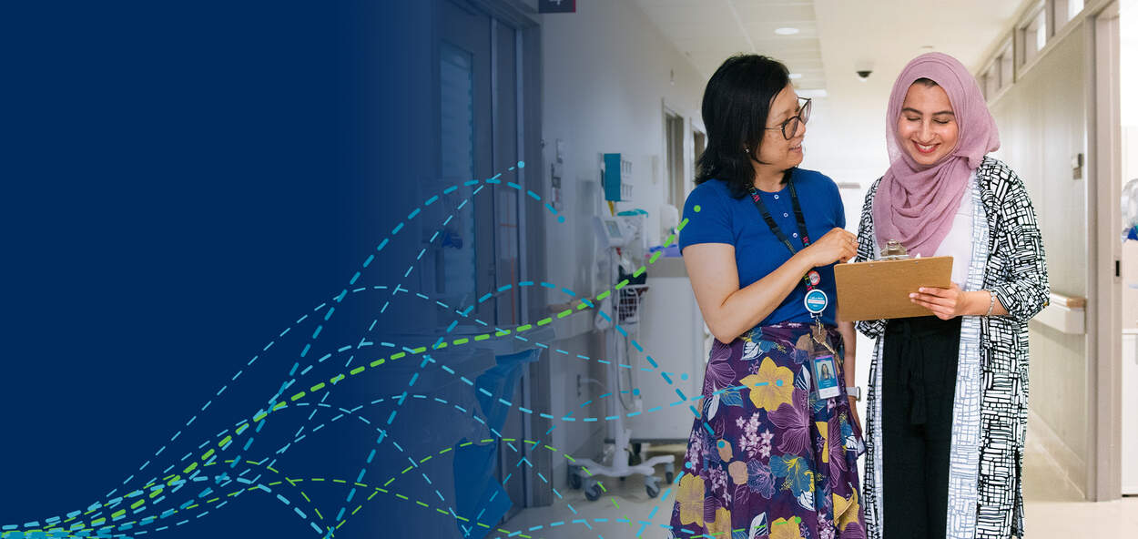 Student with preceptor in hallway of Women's College Hospital